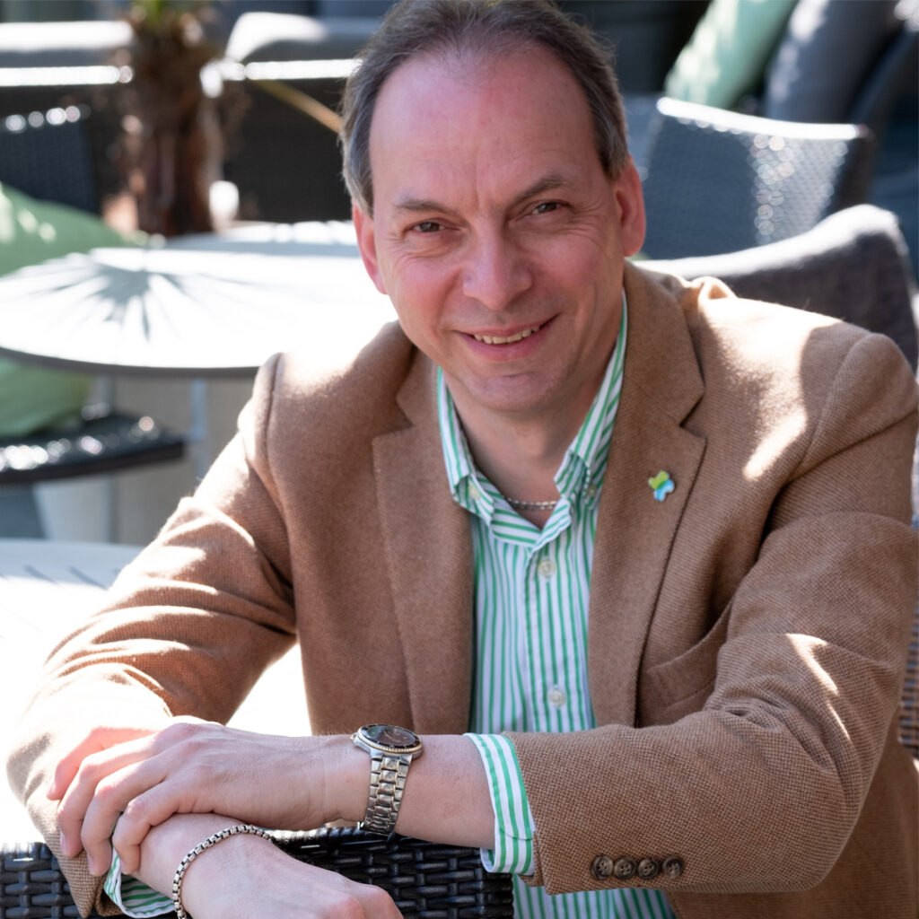Andrew Weller Man in brown suit and striped shirt with watch and Kidney Cancer Canada pin - Andrew Weller.