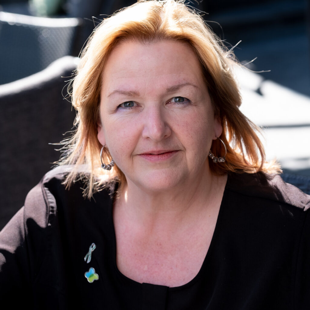 Christine Collins Woman in black shirt with ribbon and Kidney Cancer Canada logo pin - Christine Collins.