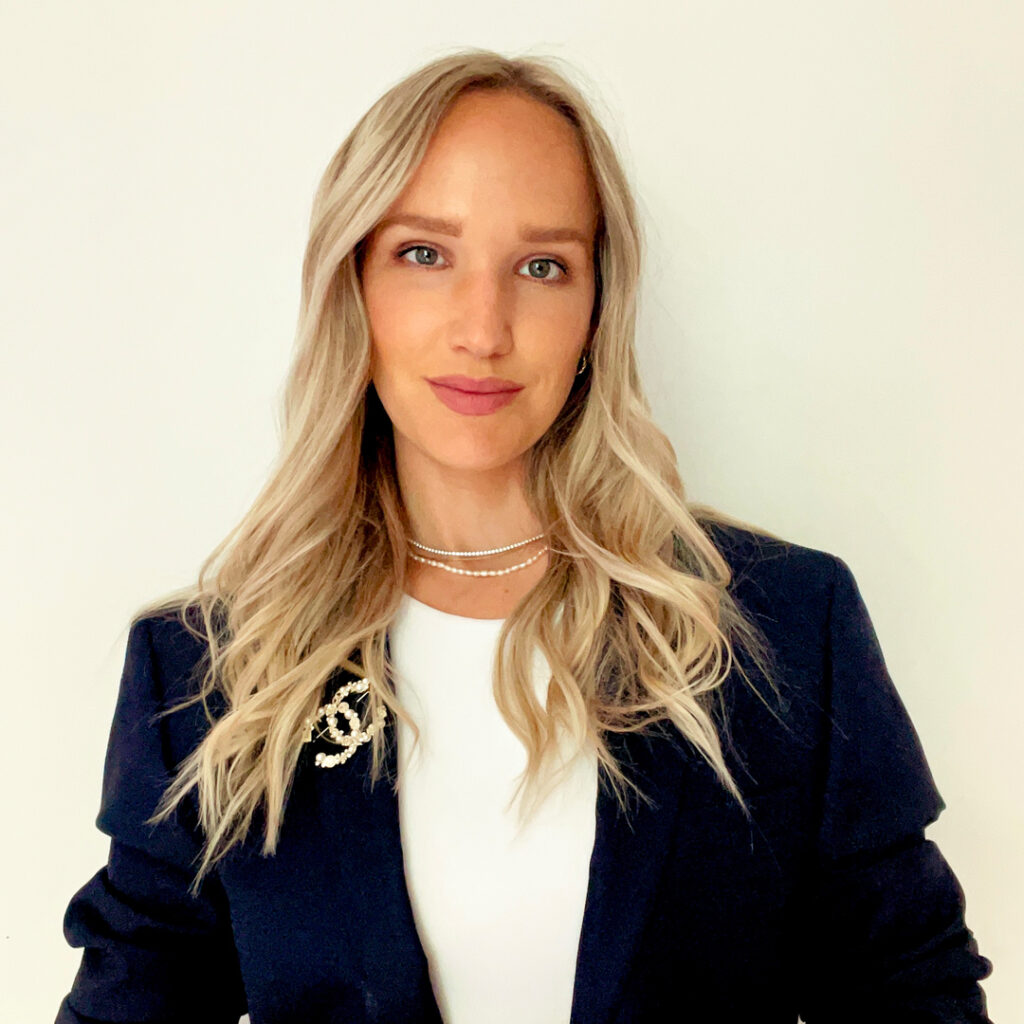 Paige Buzilo Woman wearing navy blue blazer and white shirt - Paige Buzilo.